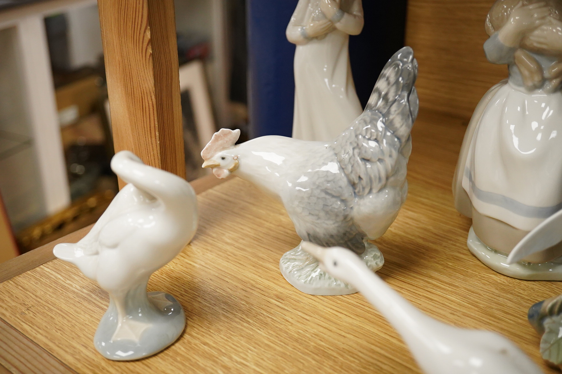 A group of Copenhagen, Nao and Lladro figures to include birds, together with a Royal Copenhagen vase, largest 21cm high